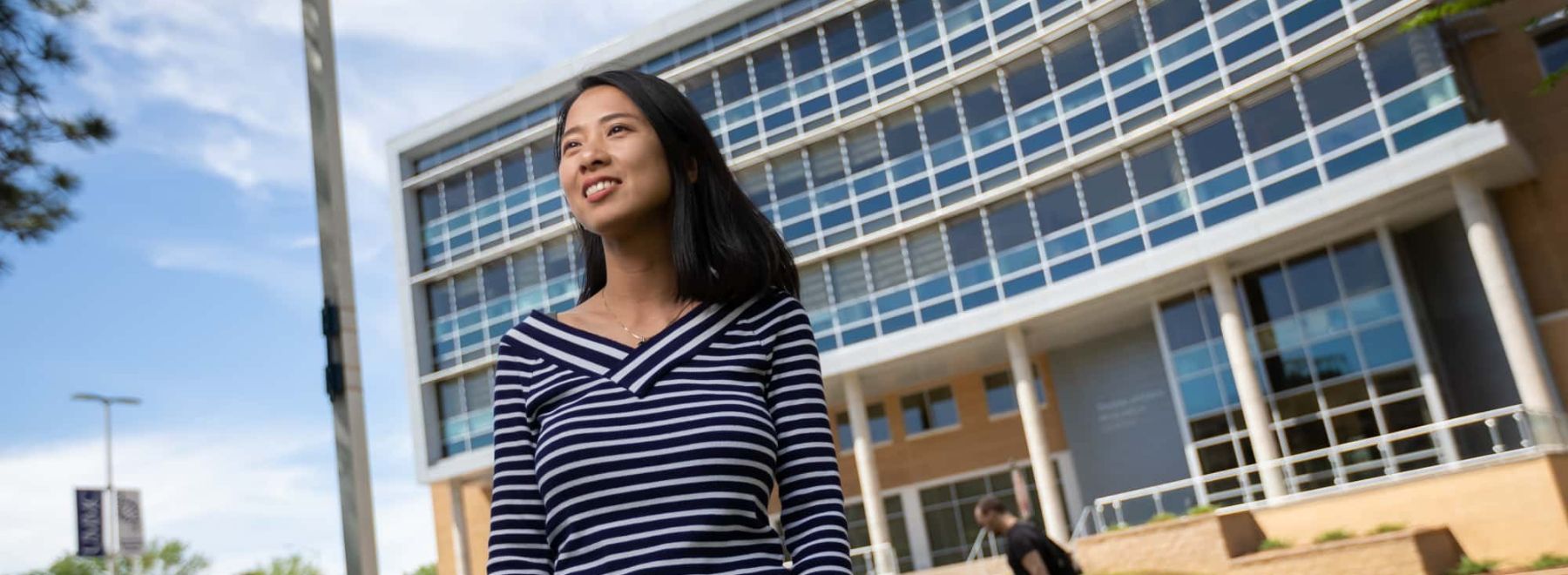 Female data science student poses outside translational research center